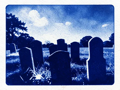 Sun-printed cemetery scene, headstone silhouettes in deep blue