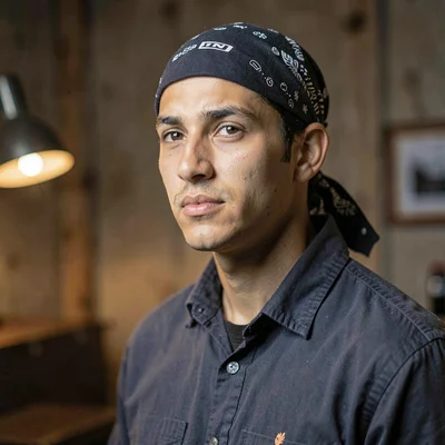 Three-quarter portrait of a young hauler with a tied-back bandana, soft directio