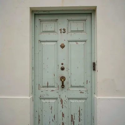 Quietly elegant photograph with Uruguayan sensibility, Faded painted door in wea