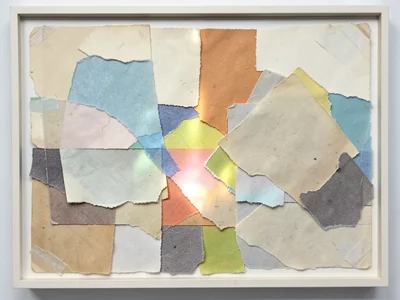 Collage of torn colored tissue papers overlapping, light passing through translu