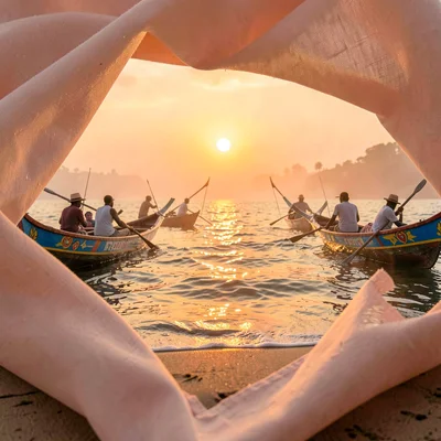 Peachy golden Dakar sunset light through sea haze, Pirogue fishermen returning a