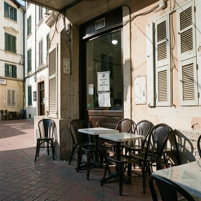 Siesta stillness, afternoon heat weight, A cafe with all chairs stacked, closed 
