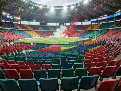 Empty stadium seats, the color pattern a wave frozen mid-crash