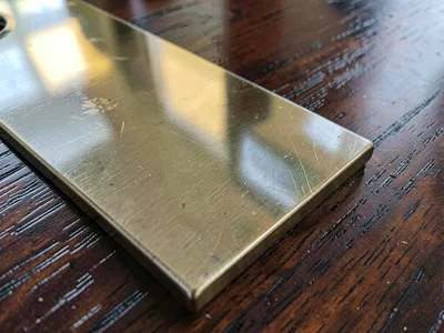 Brass inlay in dark wood