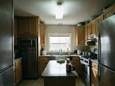 Kitchen under bright overhead fixture with hard reflections