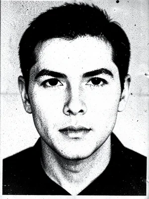 Face photocopied until features dissolve into high-contrast mask, eyes surviving