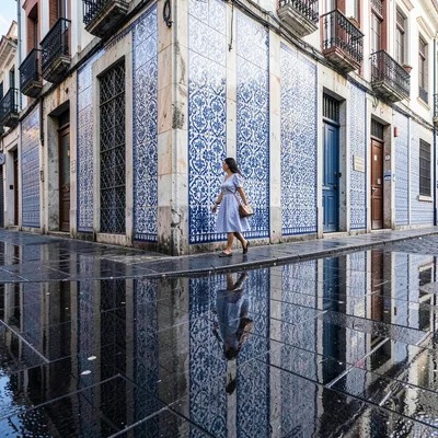Azulejo tile geometry, Portuguese ceramic culture, A woman walking along a tiled