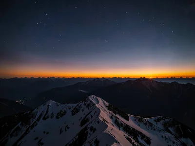 The afterglow band above mountain ridge after sun has set