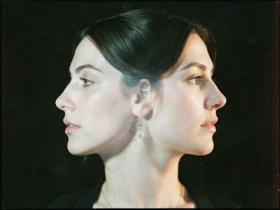 Two faces in profile double-exposed, one looking left, one right, their features