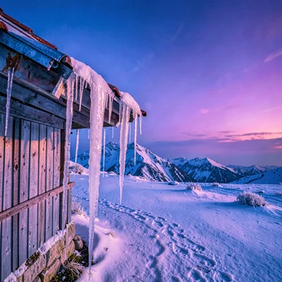 High altitude photograph, thin mountain air, Icicles hanging from a tin roof at 