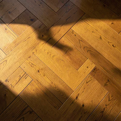 Herringbone wooden floor in warm oak, overhead view, clean and waxed