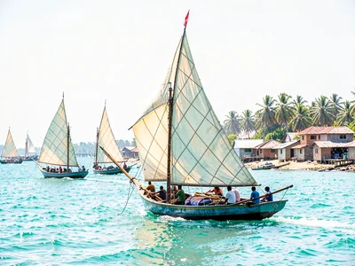 Brilliant Indian Ocean noon light in Dar es Salaam, Sailboat race, multiple dhow