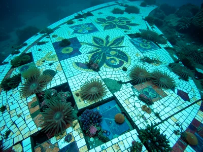 Spanish mosaic pavement continuing underwater, sea anemones growing in tile gaps