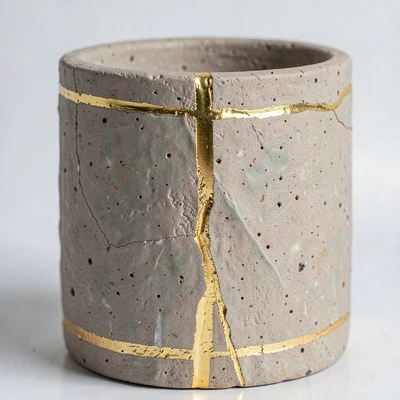Gold seam detail on rough stoneware — texture of both clay body and lacquer line