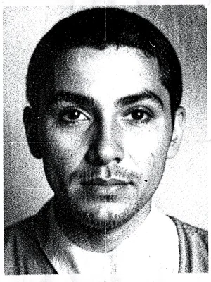 A human face degraded through 15 generations of photocopying, features barely re