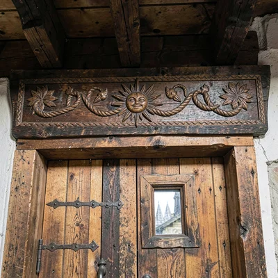 Maramures wooden craft, hand-carved church detail, Carved door lintel with sun a