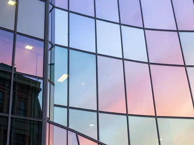 Facade panels catching different sky colors at angles