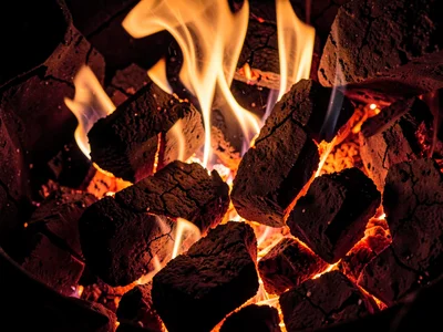 Coal fire showing orange through crack pattern