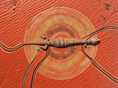 Sand ripples crossing red desert floor, aerial view, serpentine tracks of a liza