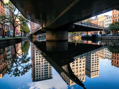 Bridge reflected in urban waterway