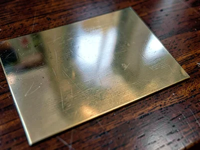 Brass inlay in dark wood