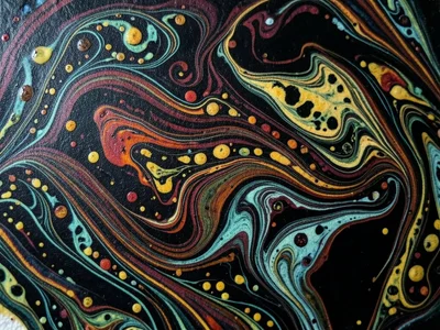 Dark ground marbling, patterns created on black-tinted surface, colors emerging 