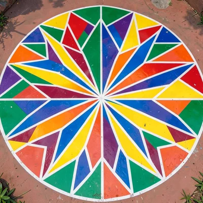 Overhead view of painted courtyard floor — geometric star pattern radiating from