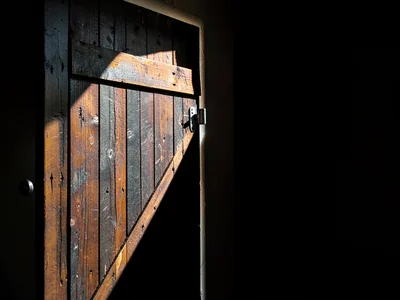 Barn door beam cutting through dark