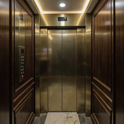 Luxury hotel elevator interior with brass and mahogany