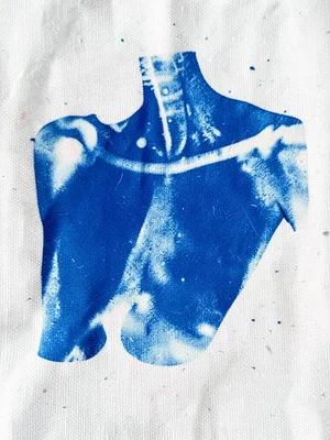 A collarbone and chin impression on cyanotype — fragmented body detail, blue on 