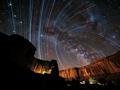 Trails over canyon walls dark silhouette