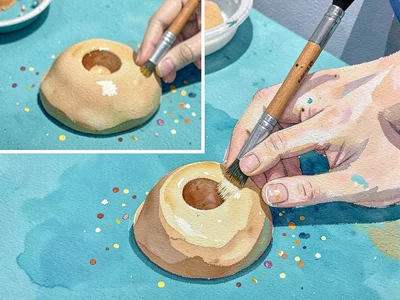 Hands shaping a soft mound of clay-colored gouache shape on a teal table, brush