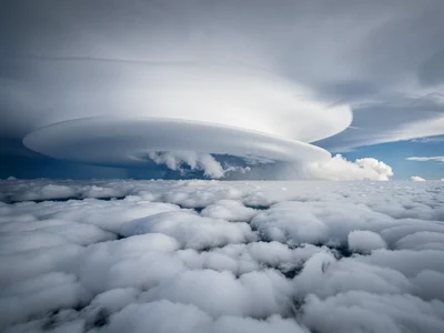 Storm anvil spreading at altitude showing smooth glaciated texture