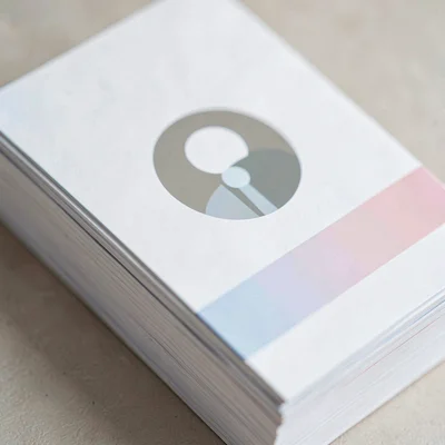 Tight crop of an employee-profile card stack showing a round abstract avatar and