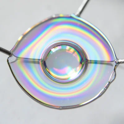 Bubble within a bubble, inner sphere visible through outer membrane, double irid