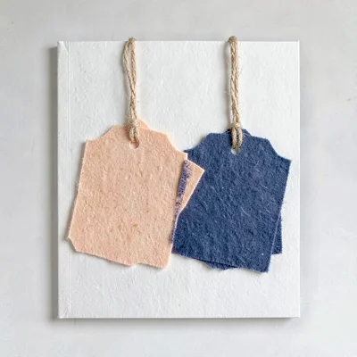 Two-color riso program-cover motif of stacked halftone craft tags swinging on a