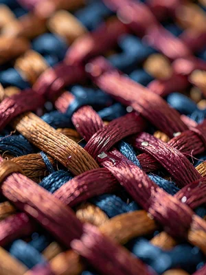 Basketweave silk in cochineal-rose shows chunky lustrous crossings with characte