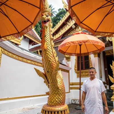 Lanna temple detail, Chiang Mai sacred ornament, orange umbrellas shading temple