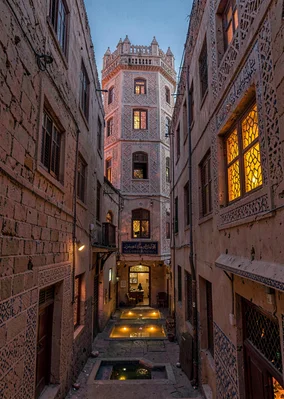 Colored light through qamariya windows in Sana'a, Yemen, narrow old city alley w