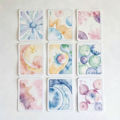 A card-deck loose-spread layout of twenty cards laid out in three rows with over