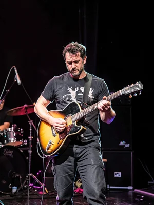 Guitarist on stage, rim outlining figure
