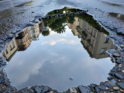 Puddle chain along tire track, series of elongated water mirrors following the d