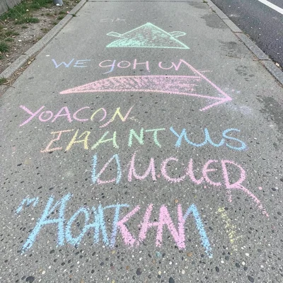 A chalk arrow and encouraging message for a marathon, the route painted in chalk