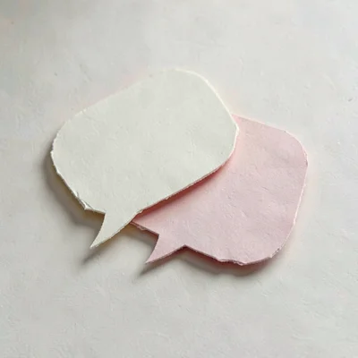 Papercraft onboarding illustration of two layered paper speech bubbles overlappi