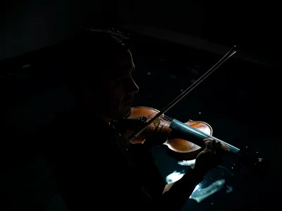 Violin and bow in pool of light