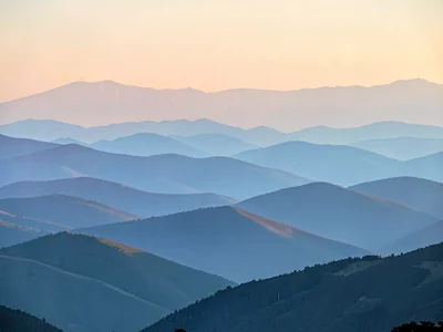 Appalachian ridges at dawn, each successive mountain range a lighter shade of bl