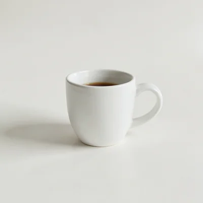 Minimalist photography of a single white coffee cup on a clean off-white background, soft natural window light, subtle s