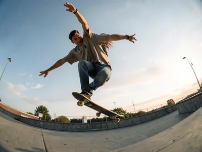 Skateboarder mid-trick with curved horizon