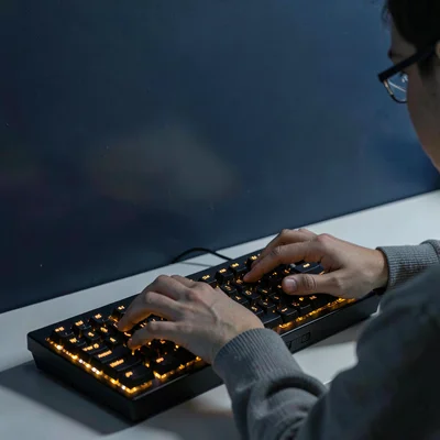 Stark Baltic minimalism, contemplative mood, Hands typing on mechanical keyboard