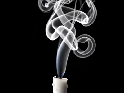 Candle snuff smoke rising in complex spiraling pattern